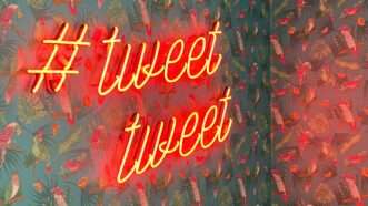 neon sign with a hashtag saying "tweet tweet"