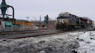 a train goes near the East Palestine, Ohio, site where a train carrying hazardous materials derailed on February 3